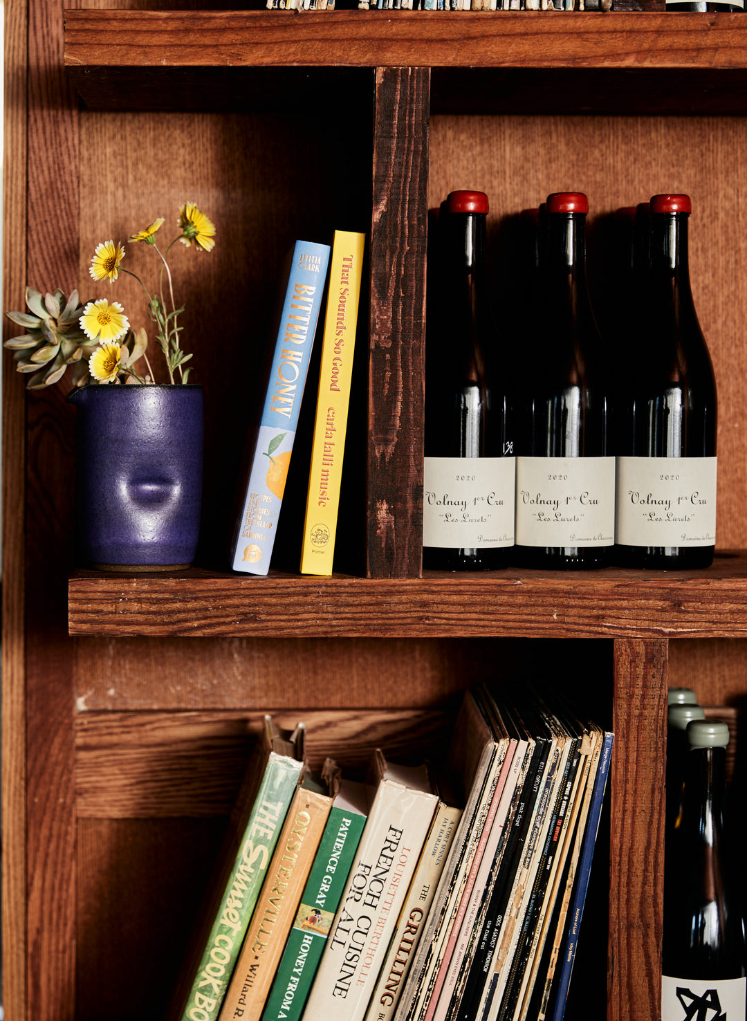 a shelf with bottles and books