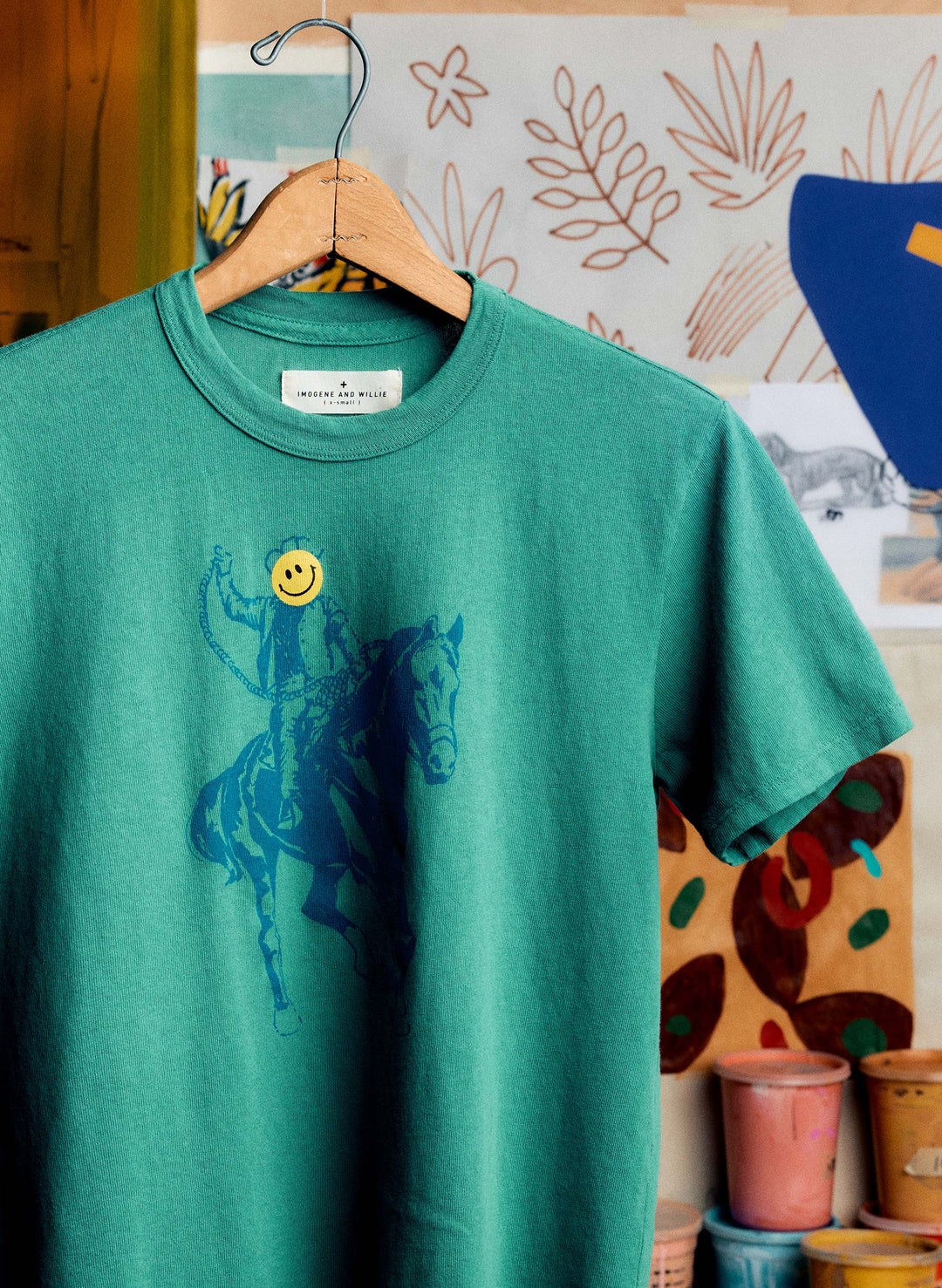 a green shirt with a blue horse on it