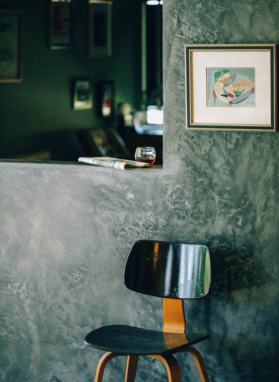a chair and a glass on a ledge
