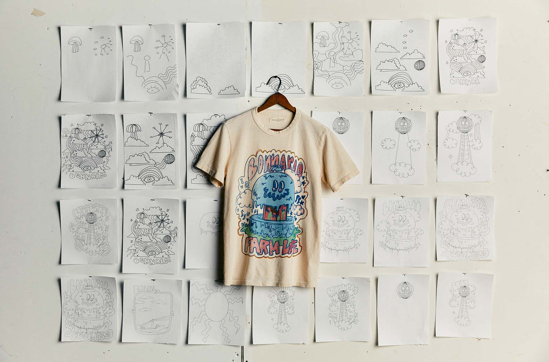 a shirt on a swinger with drawings on the wall