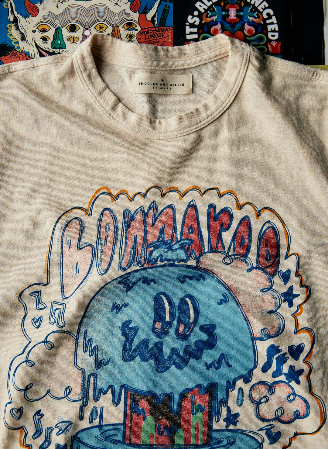 a white t-shirt with a blue cartoon on it