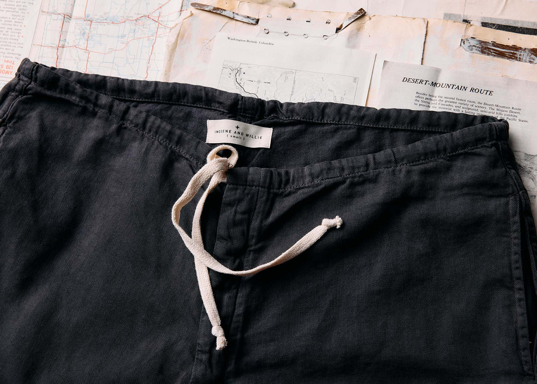 a pair of black pants with a string on top of a map