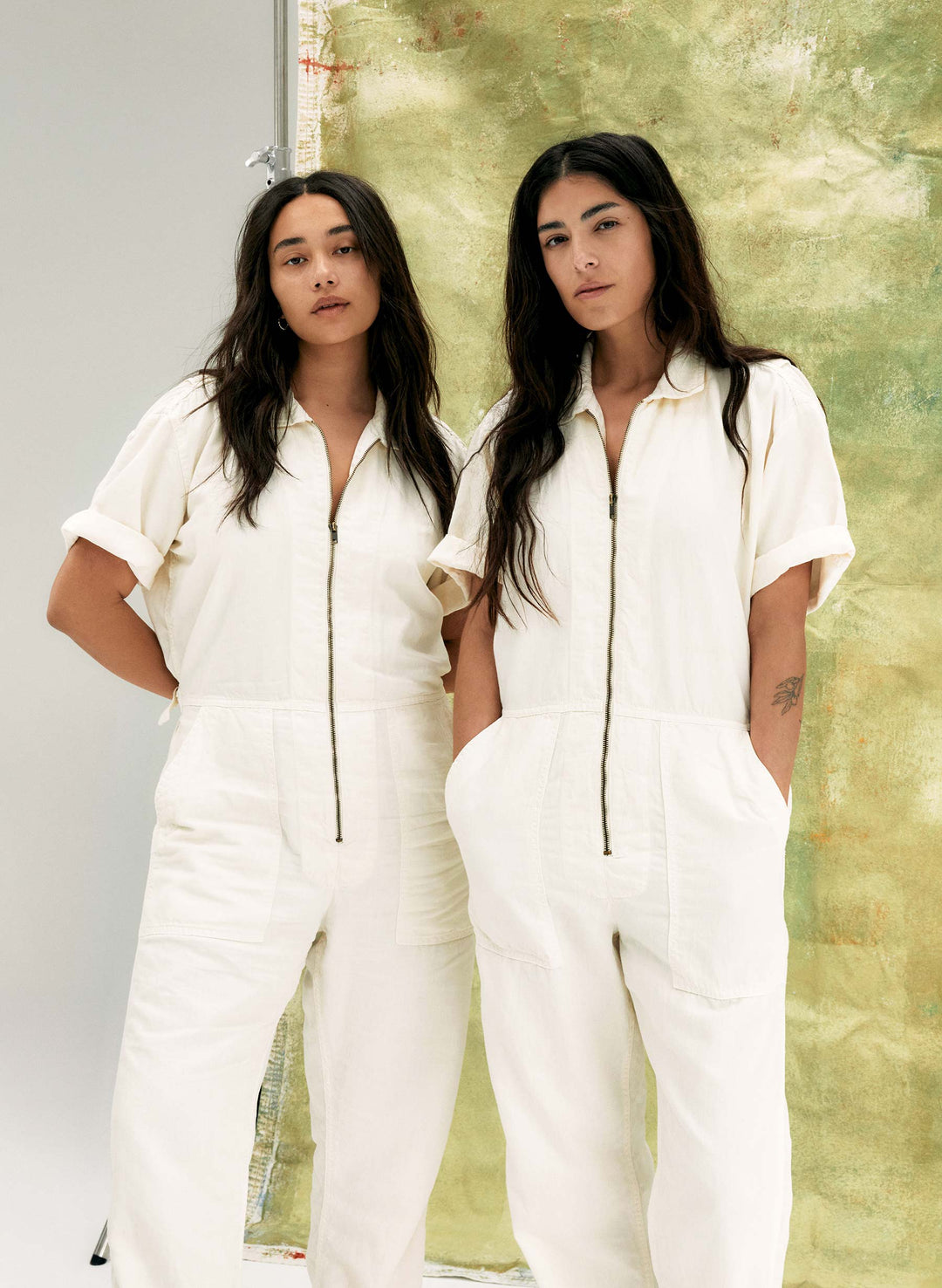 two women in white overalls