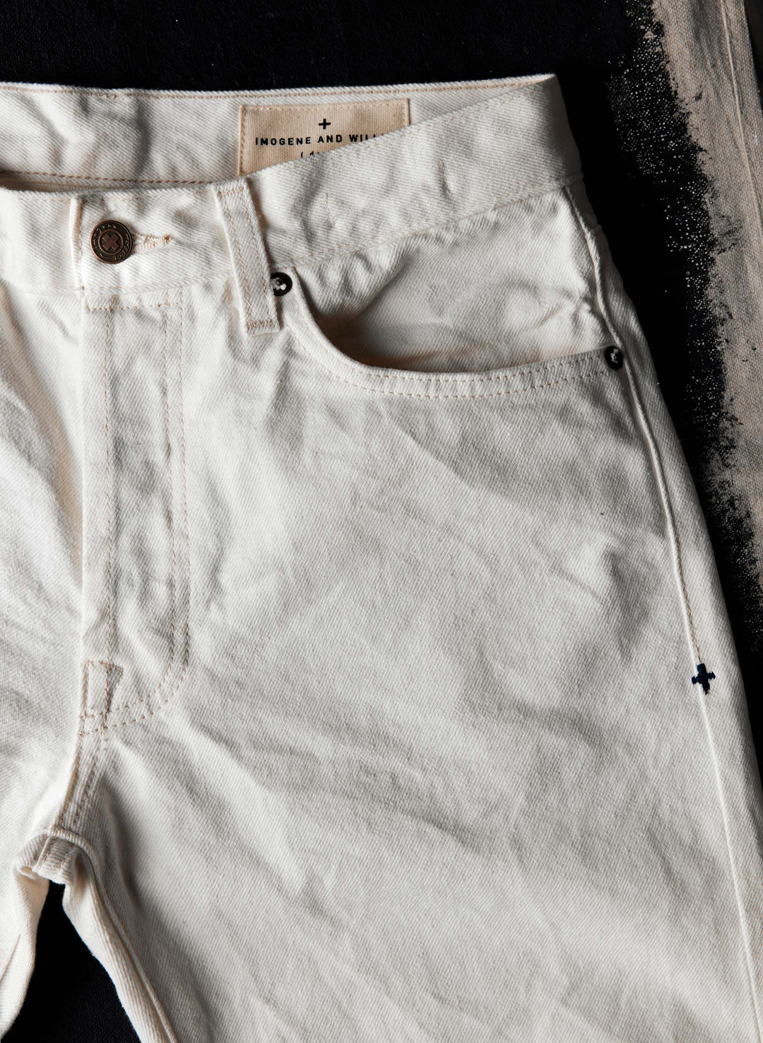 a close up of a pair of white jeans