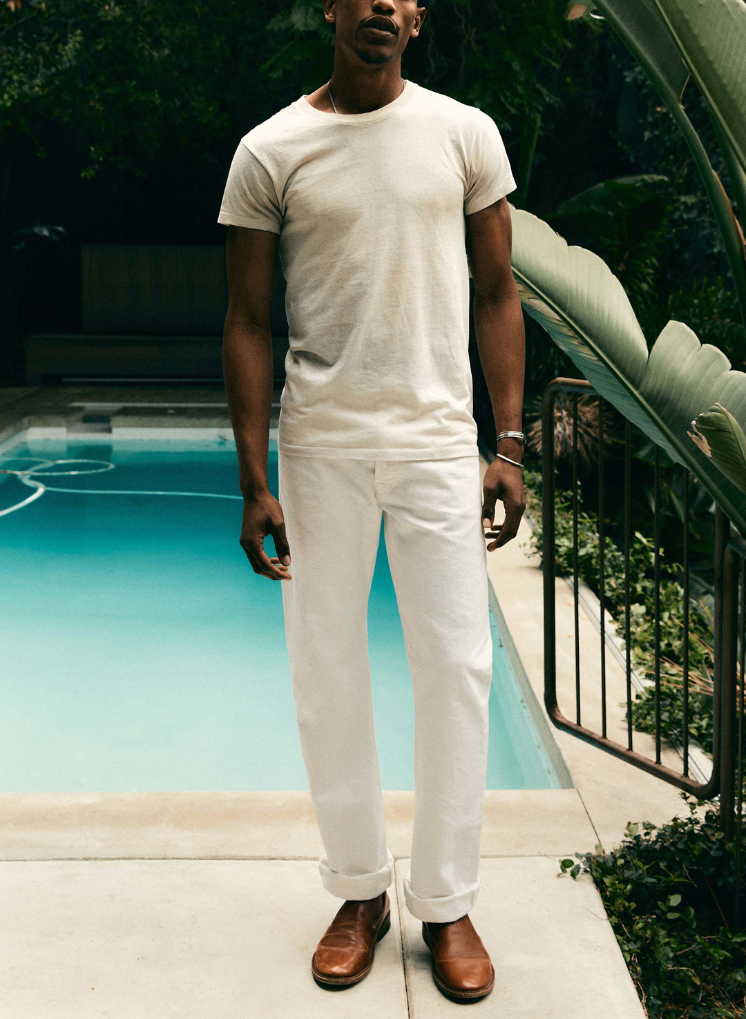 a man standing in front of a pool