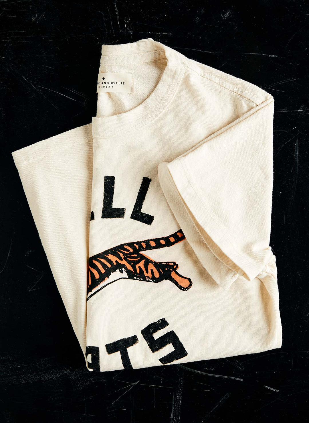 a folded white t-shirt with a tiger on it