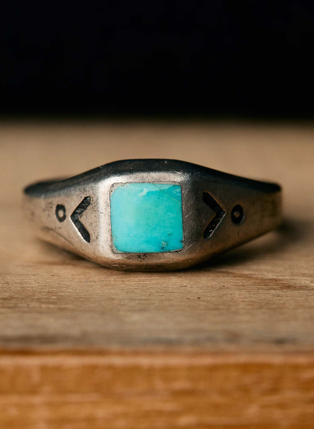 a silver ring with a blue stone on it