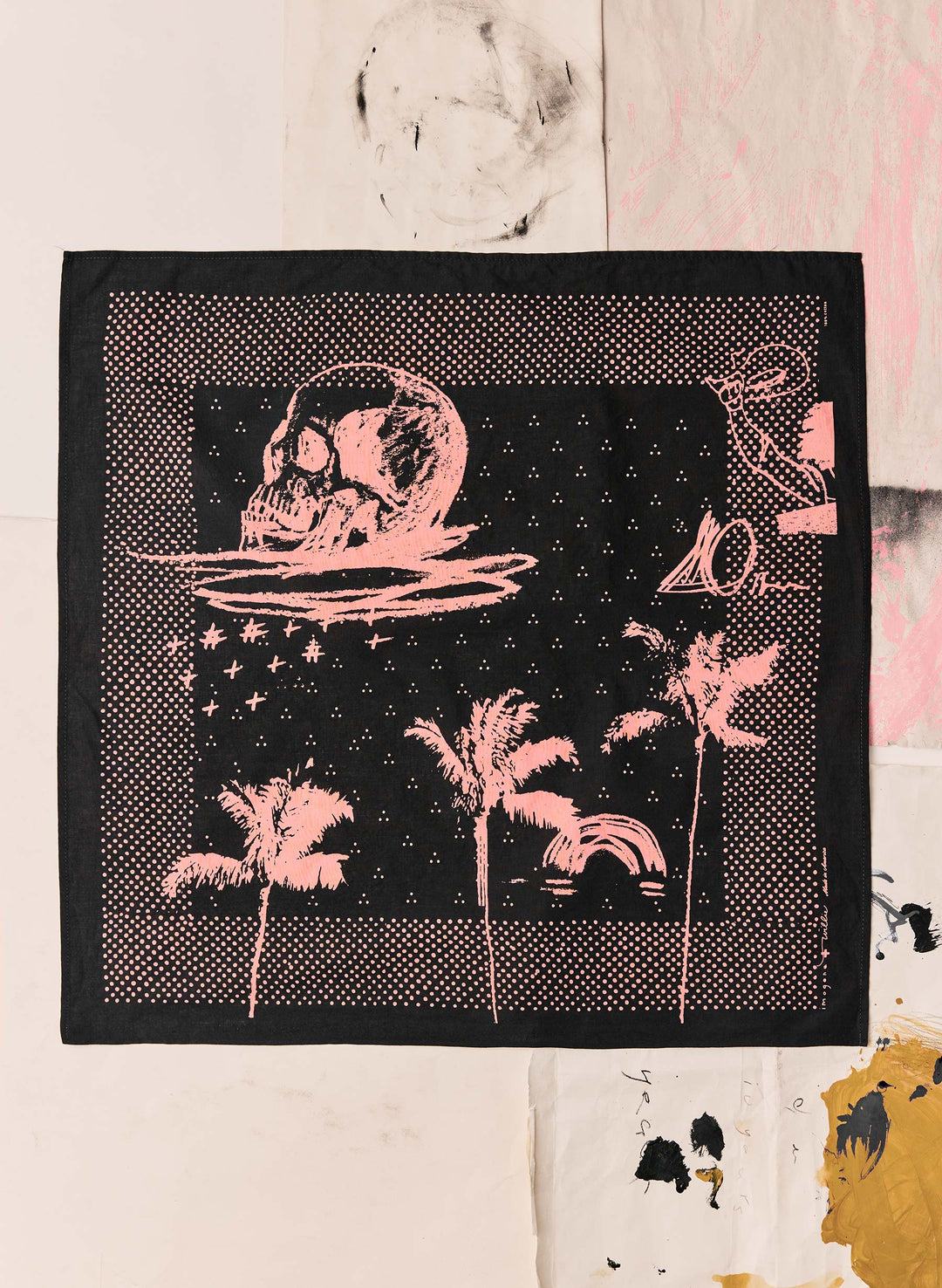 a black and pink bandana with a skull and palm trees