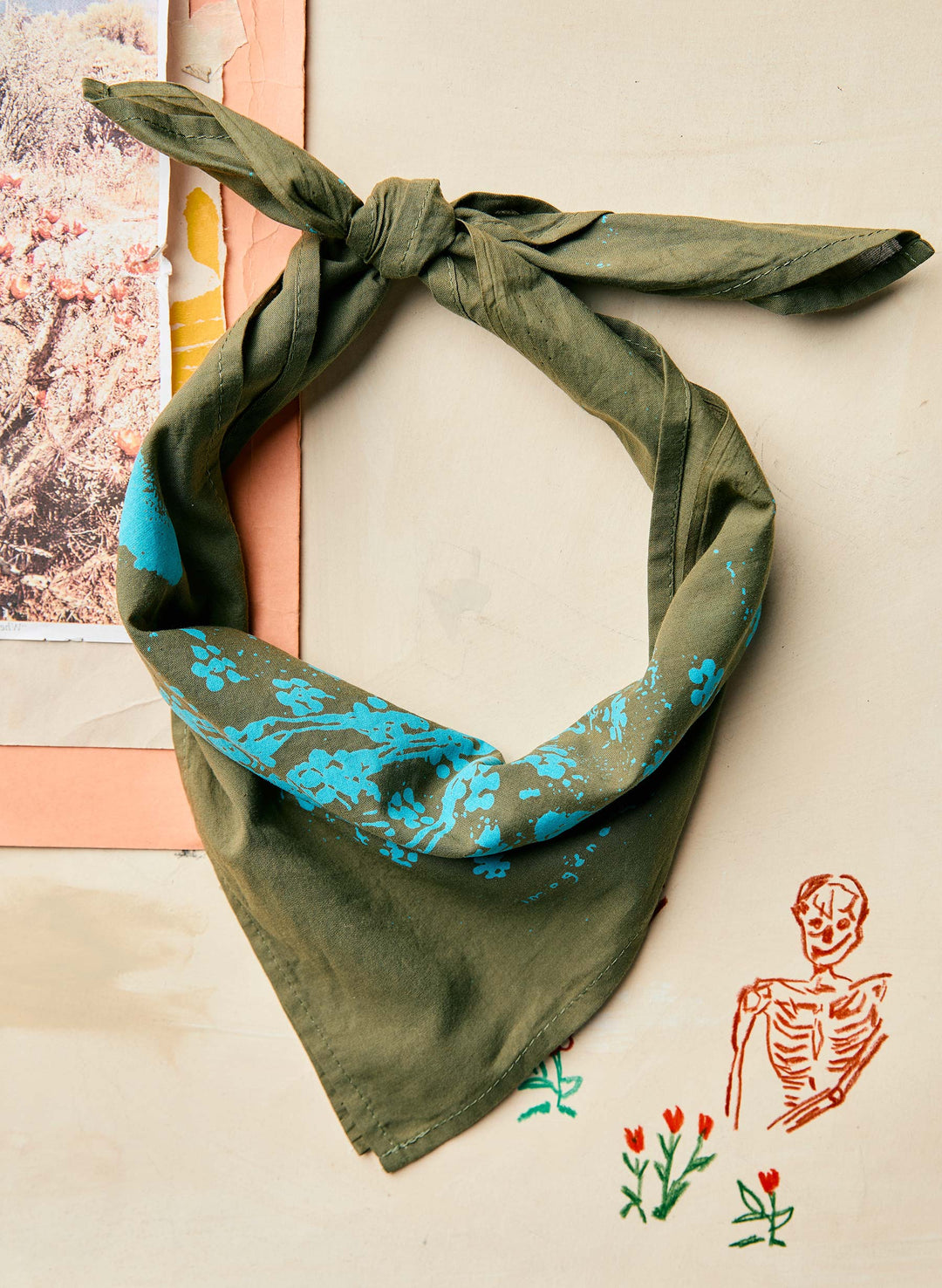 a green bandana with blue flowers on it