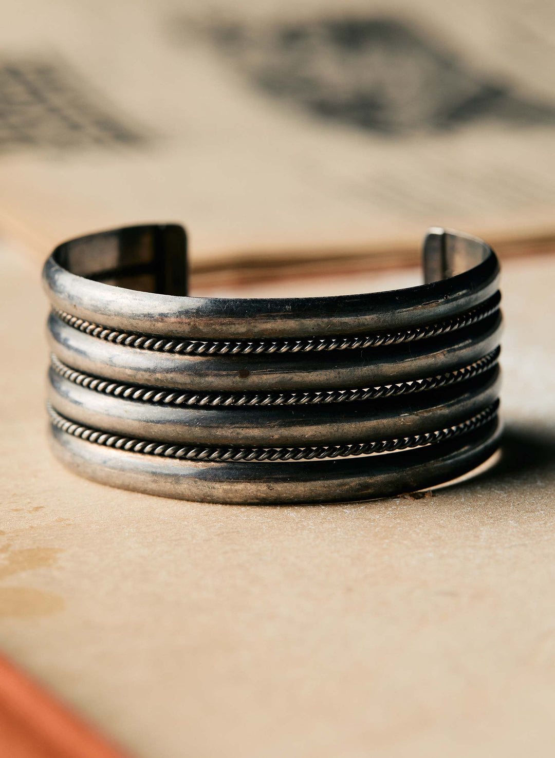 a silver bracelet on a surface