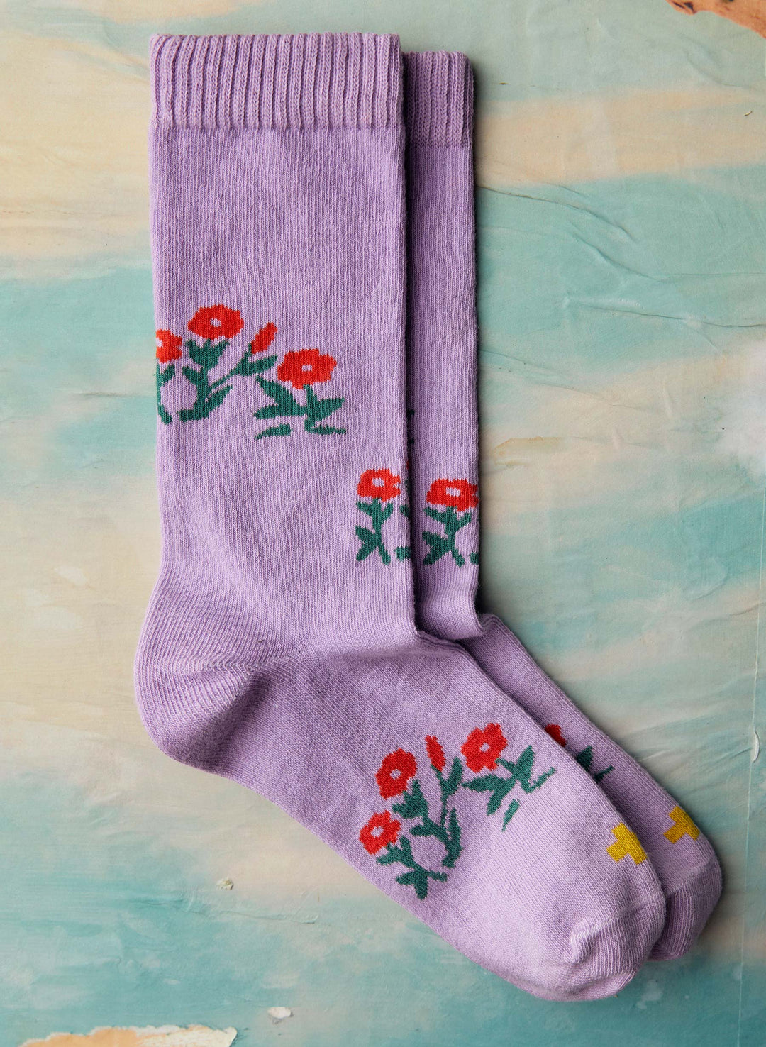 a pair of purple socks with flowers on them