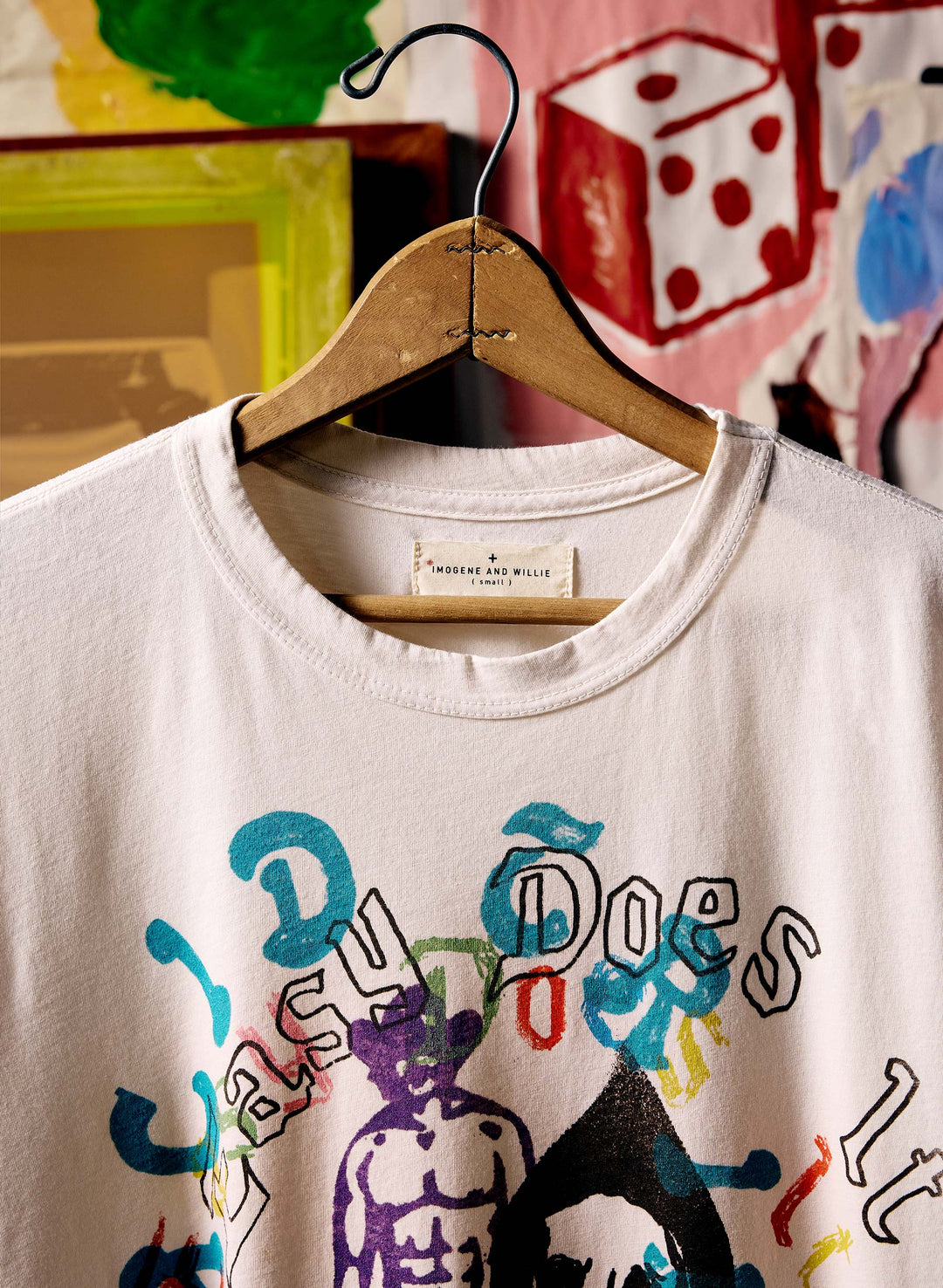 a white shirt with colorful writing on it