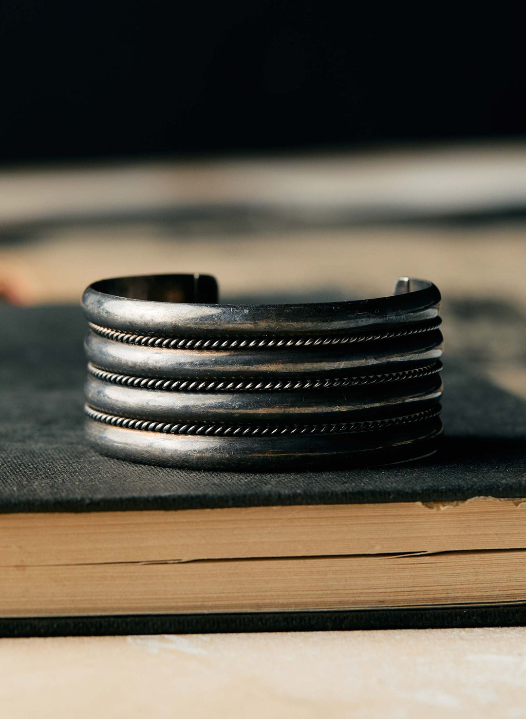 a silver bracelet on a book