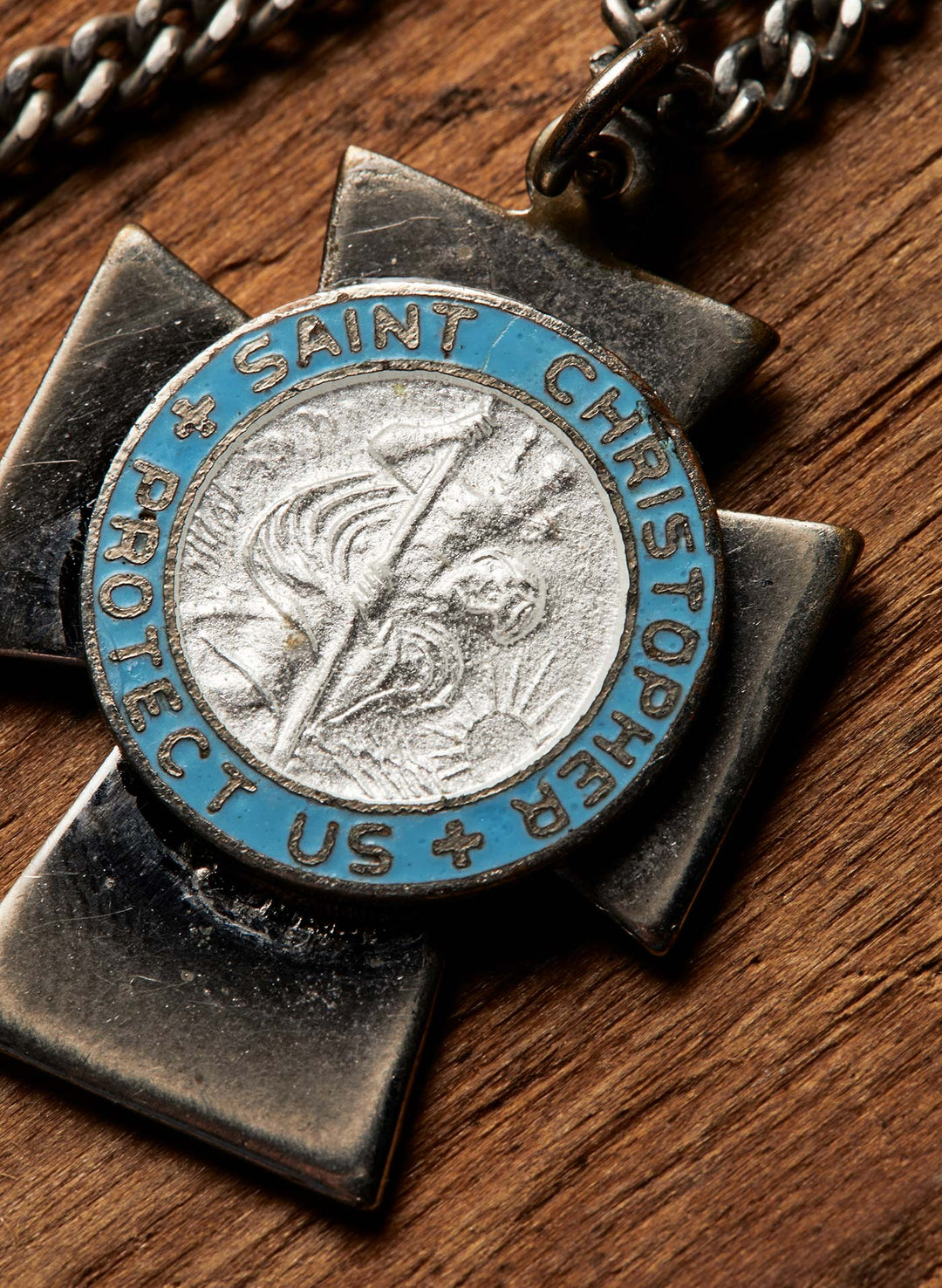 a silver and blue medallion on a wooden surface