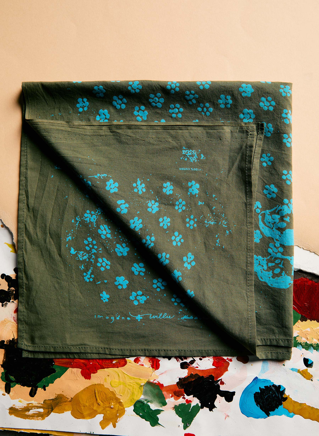 a green handkerchief with blue flowers on it