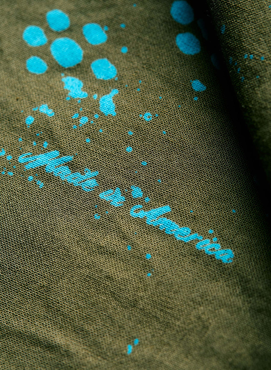 a close-up of a fabric with blue ink splatters