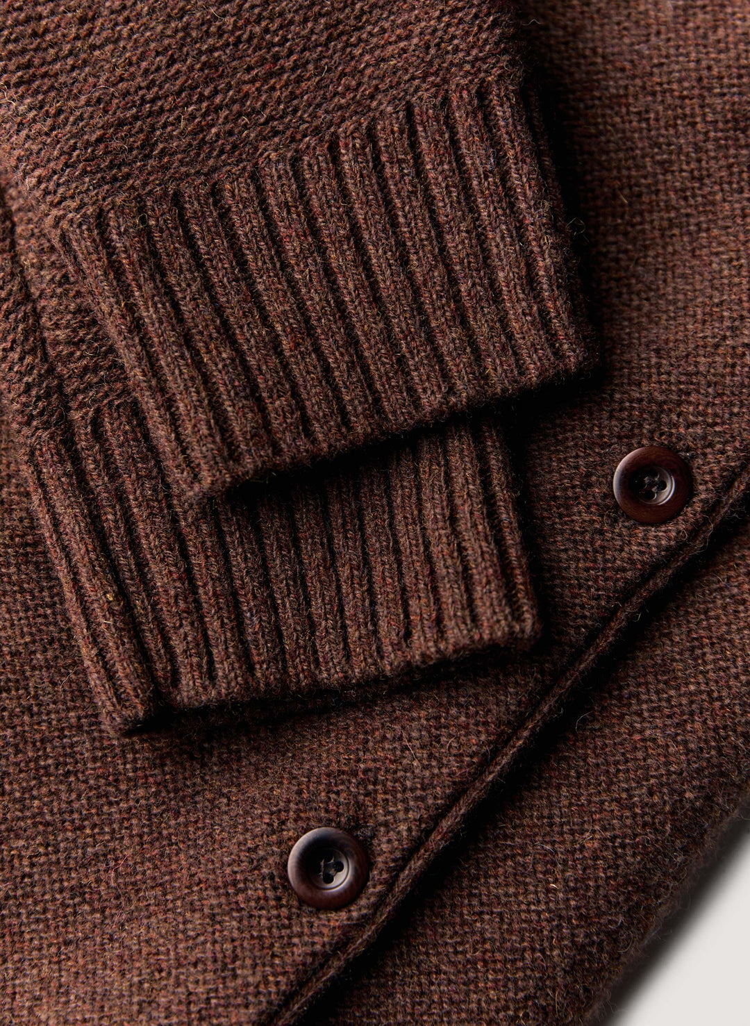 a brown sweater with buttons