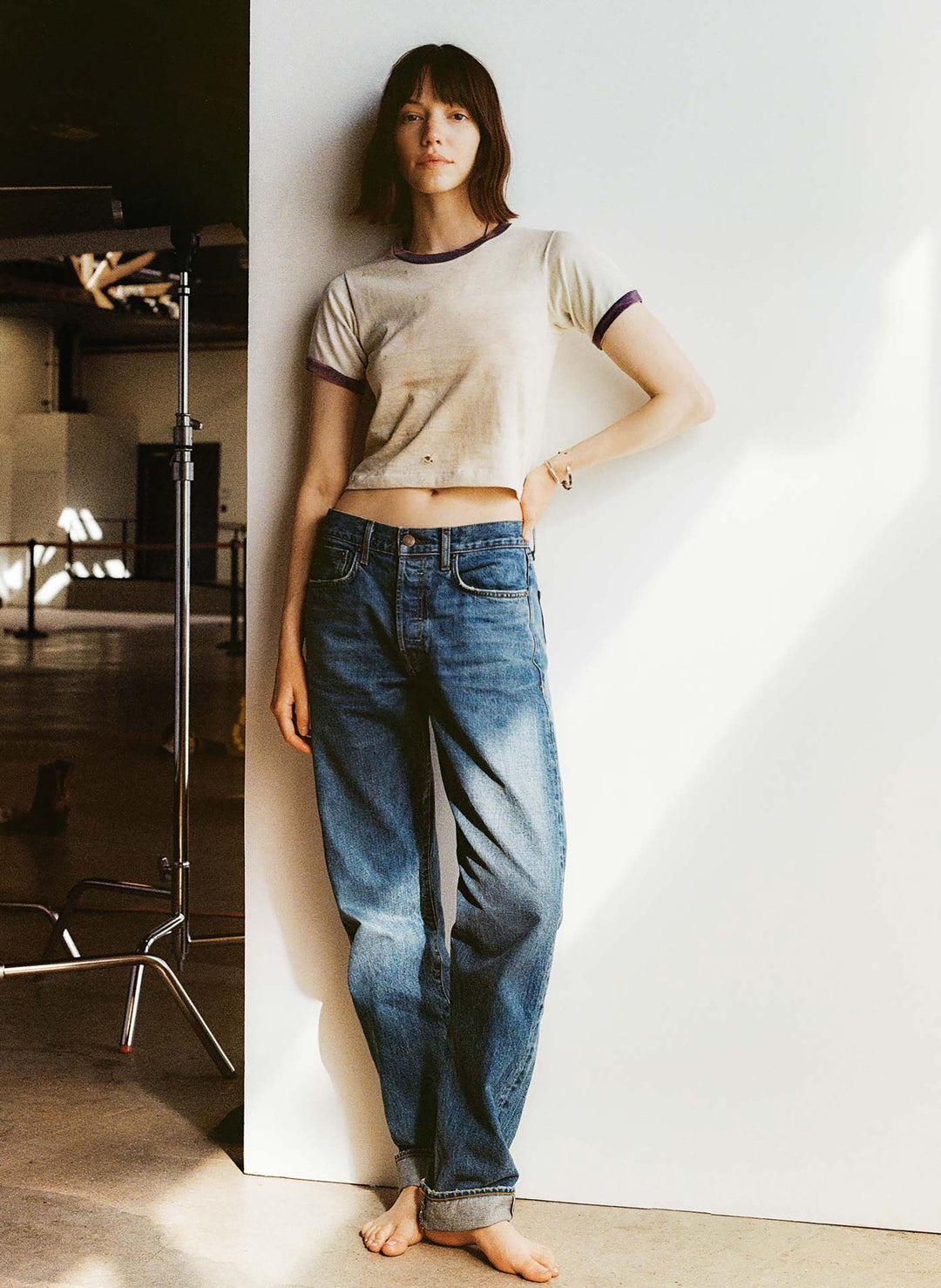 a woman leaning against a wall