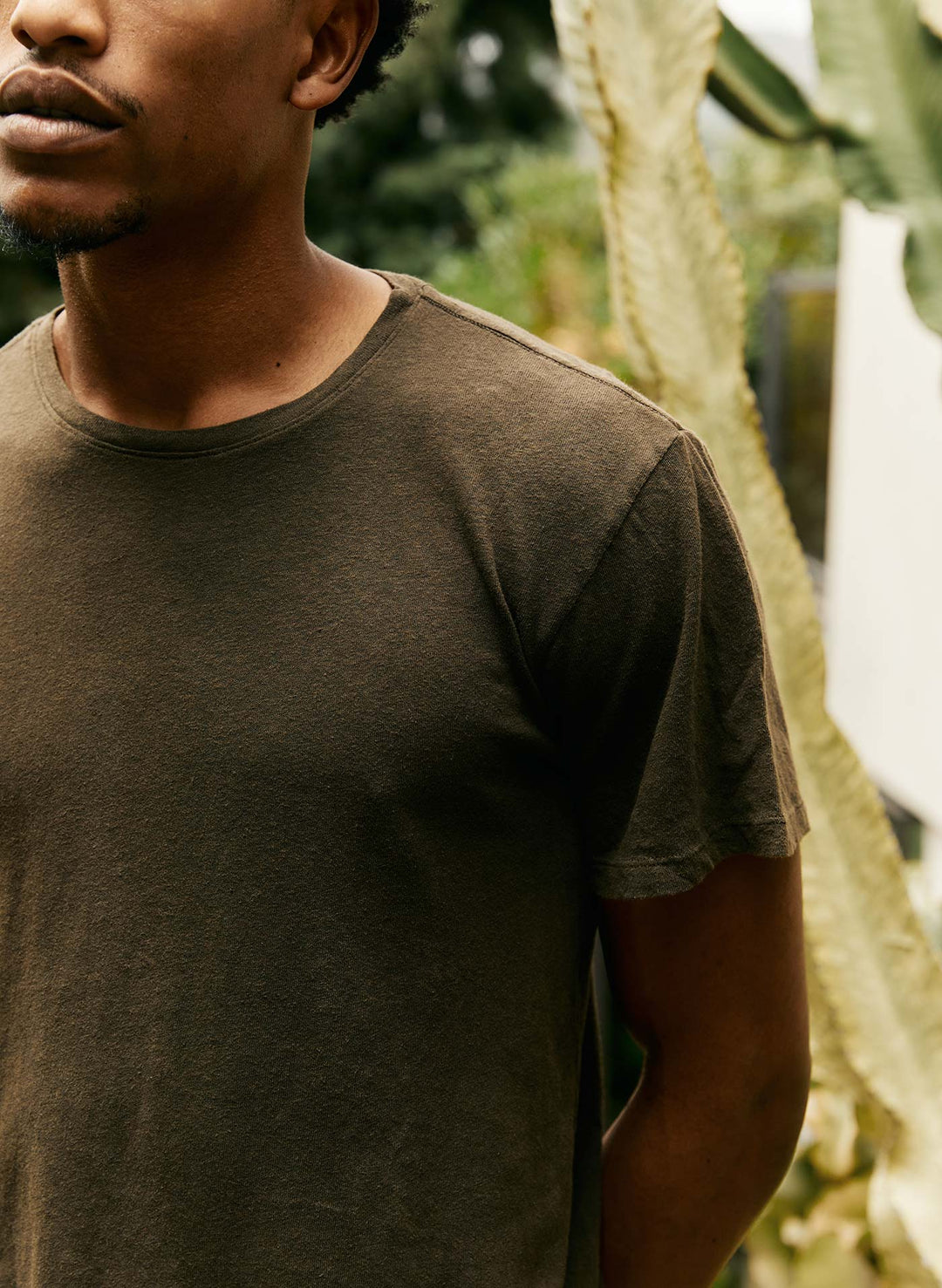 a man wearing a brown shirt