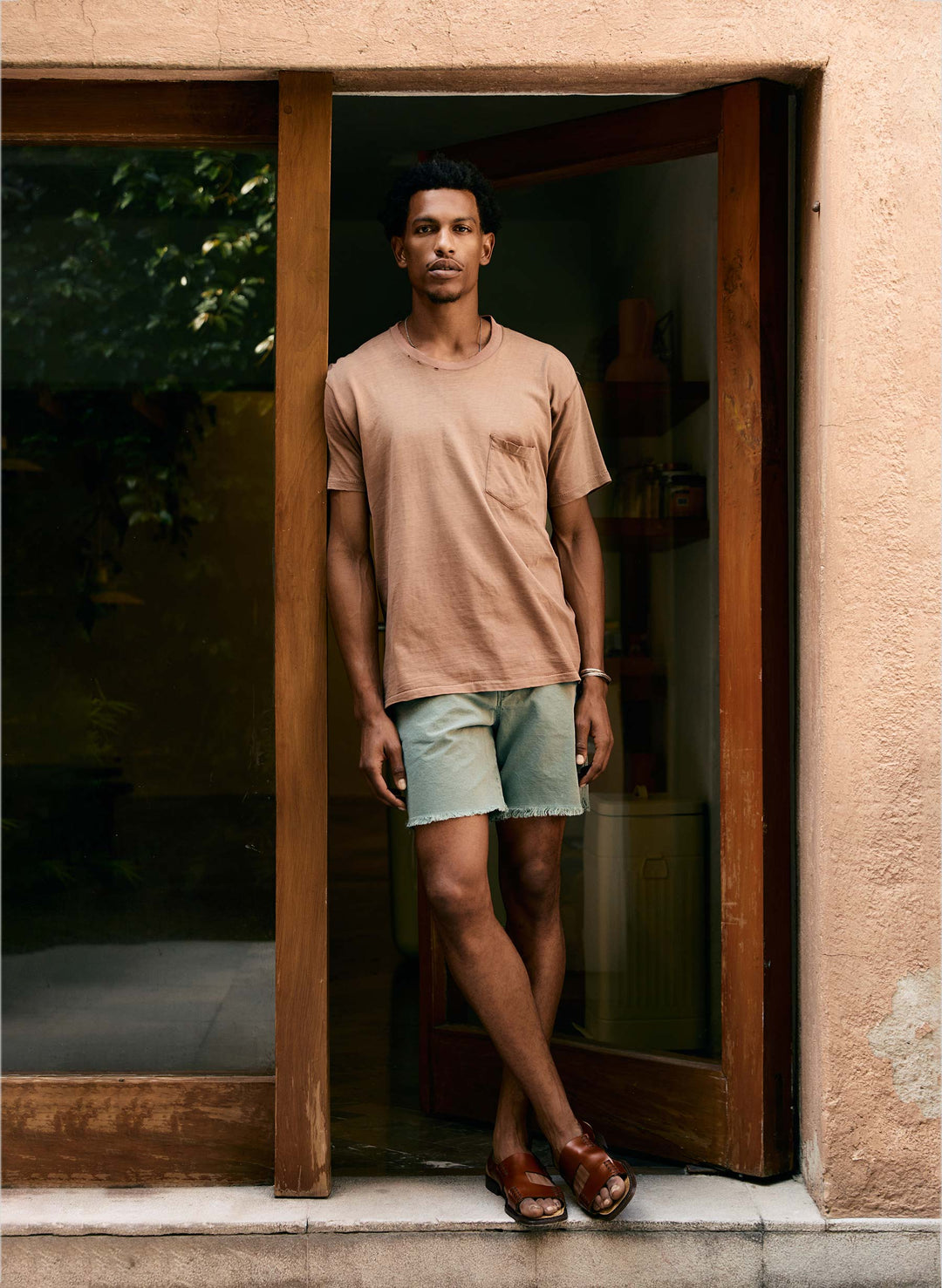 a man standing in front of a glass door