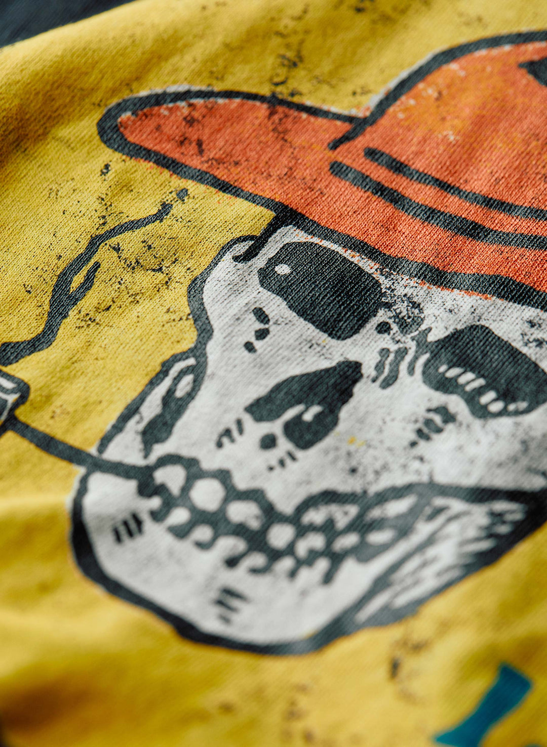 a skull on a yellow shirt