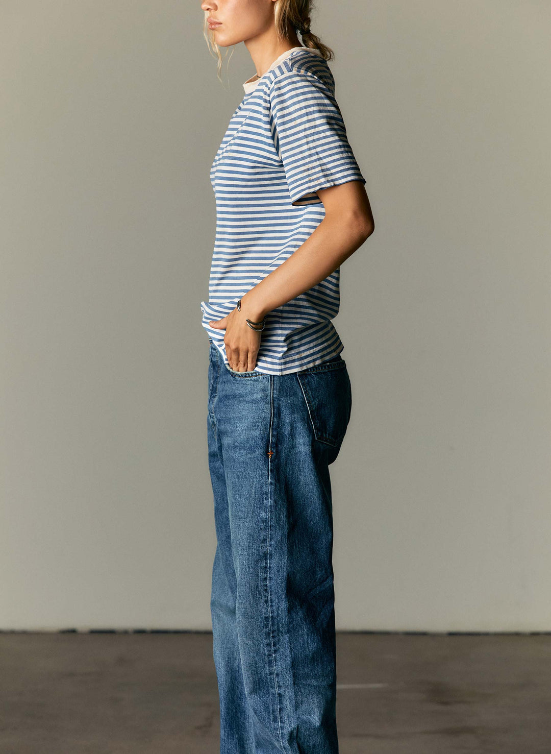 a woman in a striped shirt and jeans