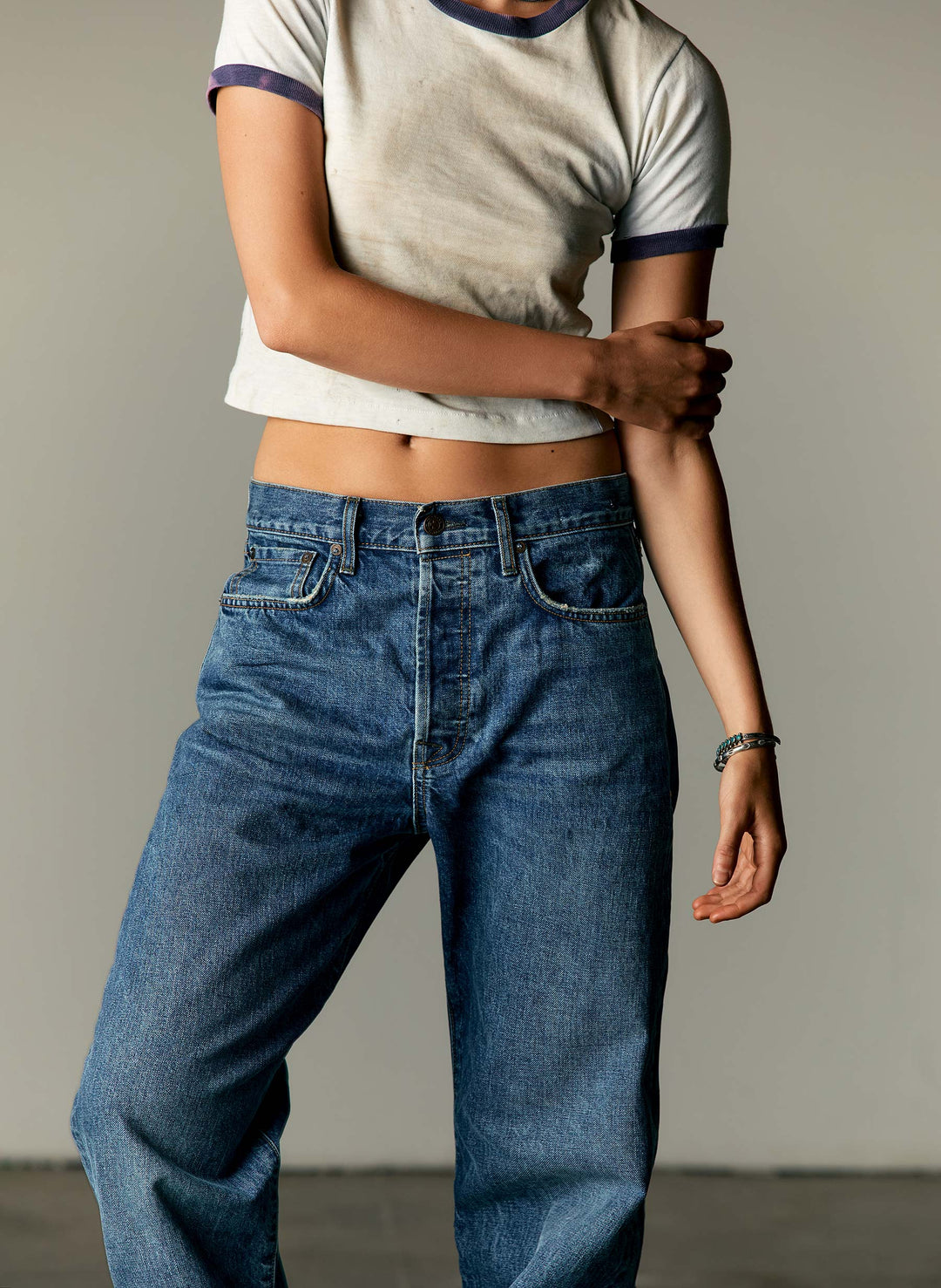 a woman in a white shirt and blue jeans