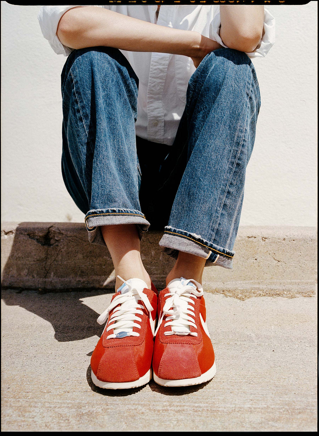 a person wearing red shoes