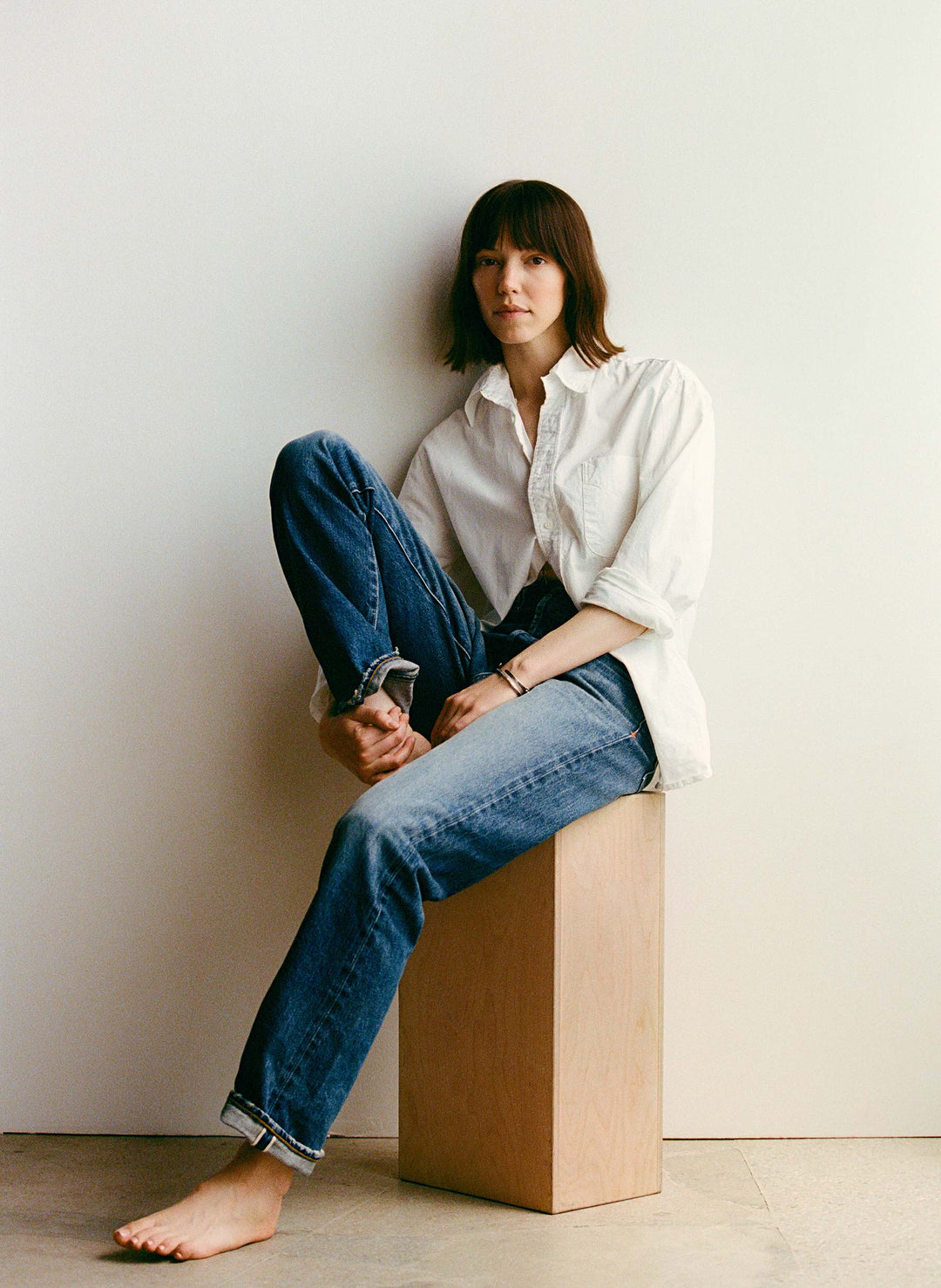 a woman sitting on a wooden box