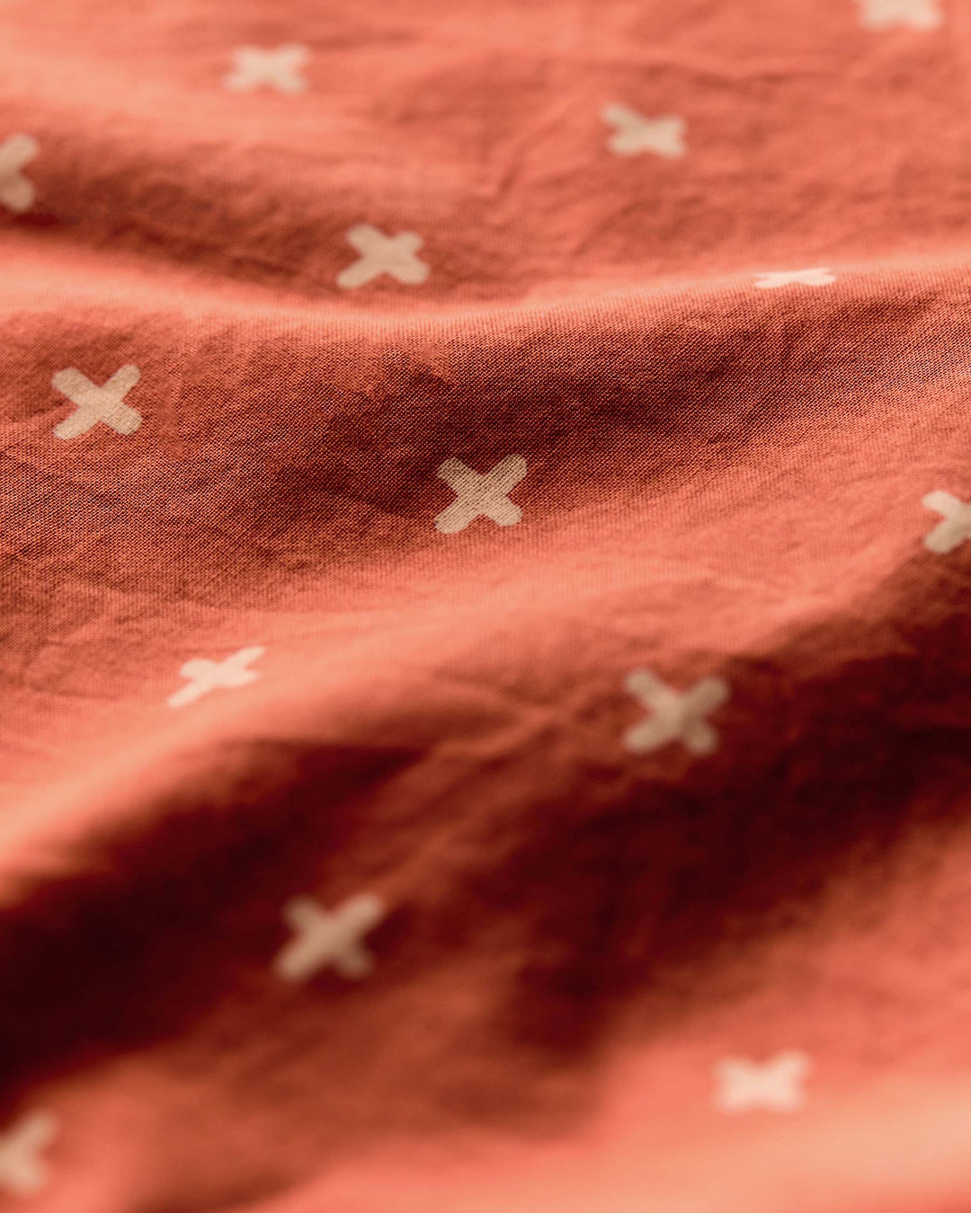 a close up of a red fabric with white crosses