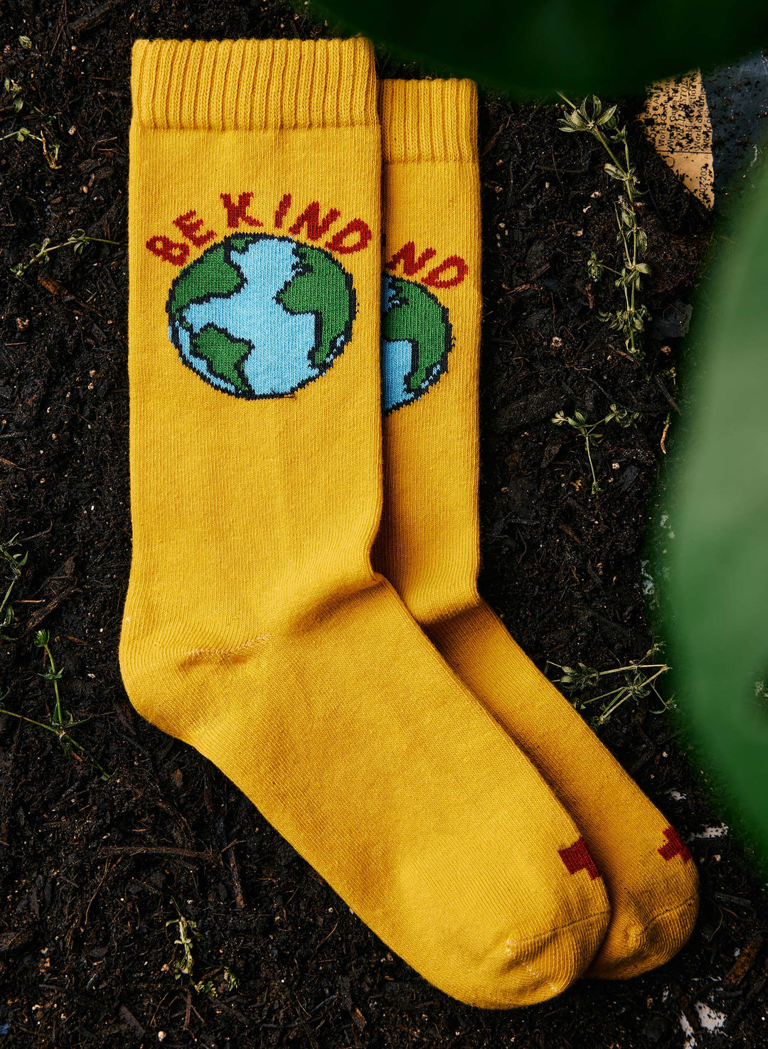 a pair of yellow socks with earth on them