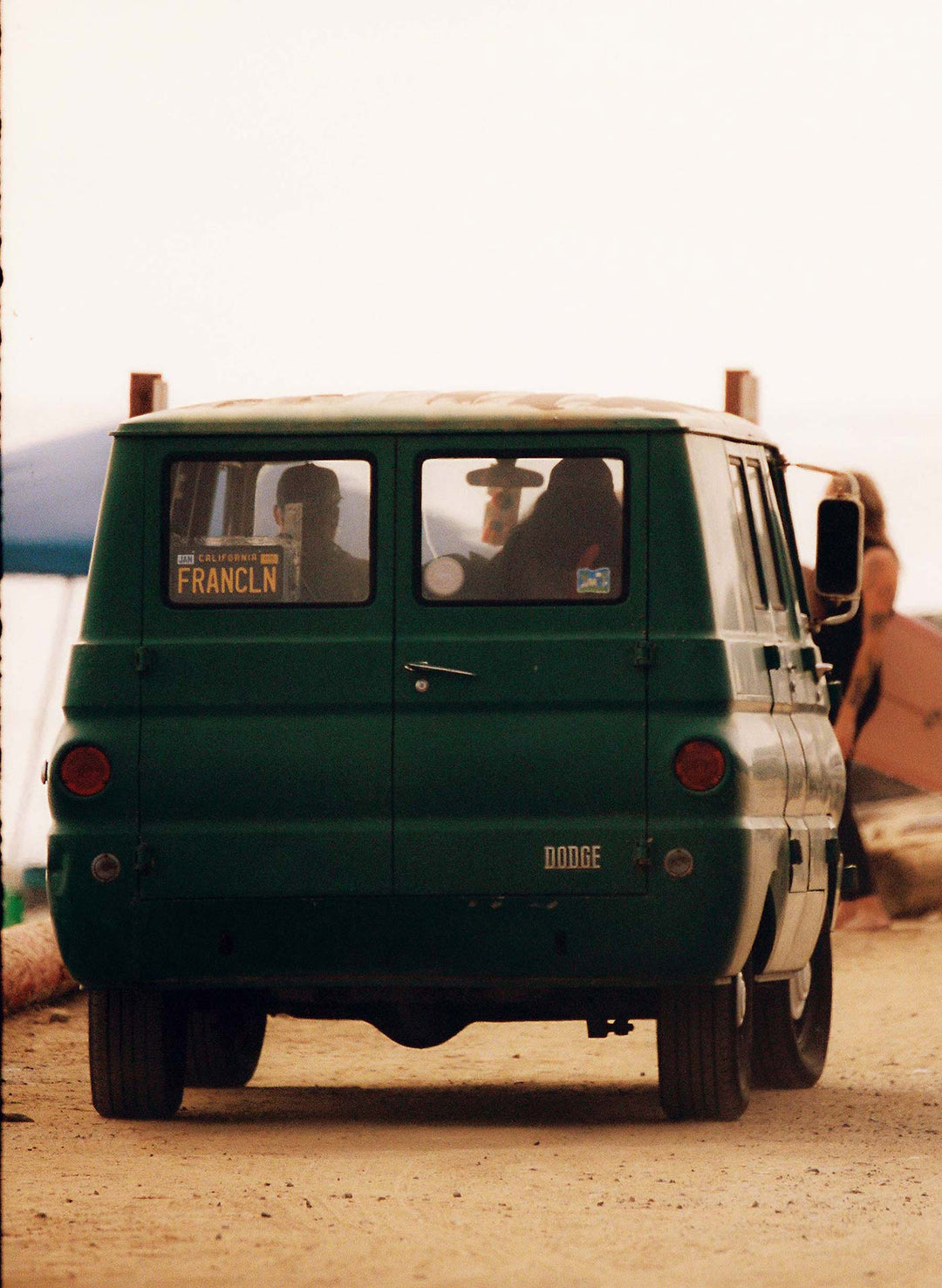 a green van on a dirt road