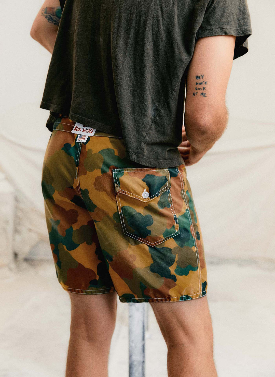 a man wearing camouflage shorts