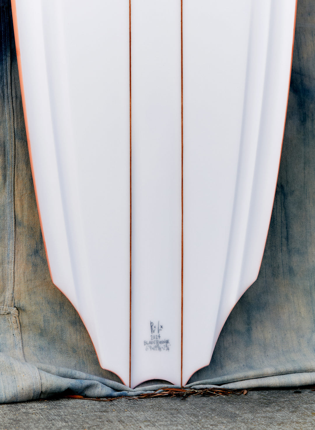 a white surfboard with red stripes