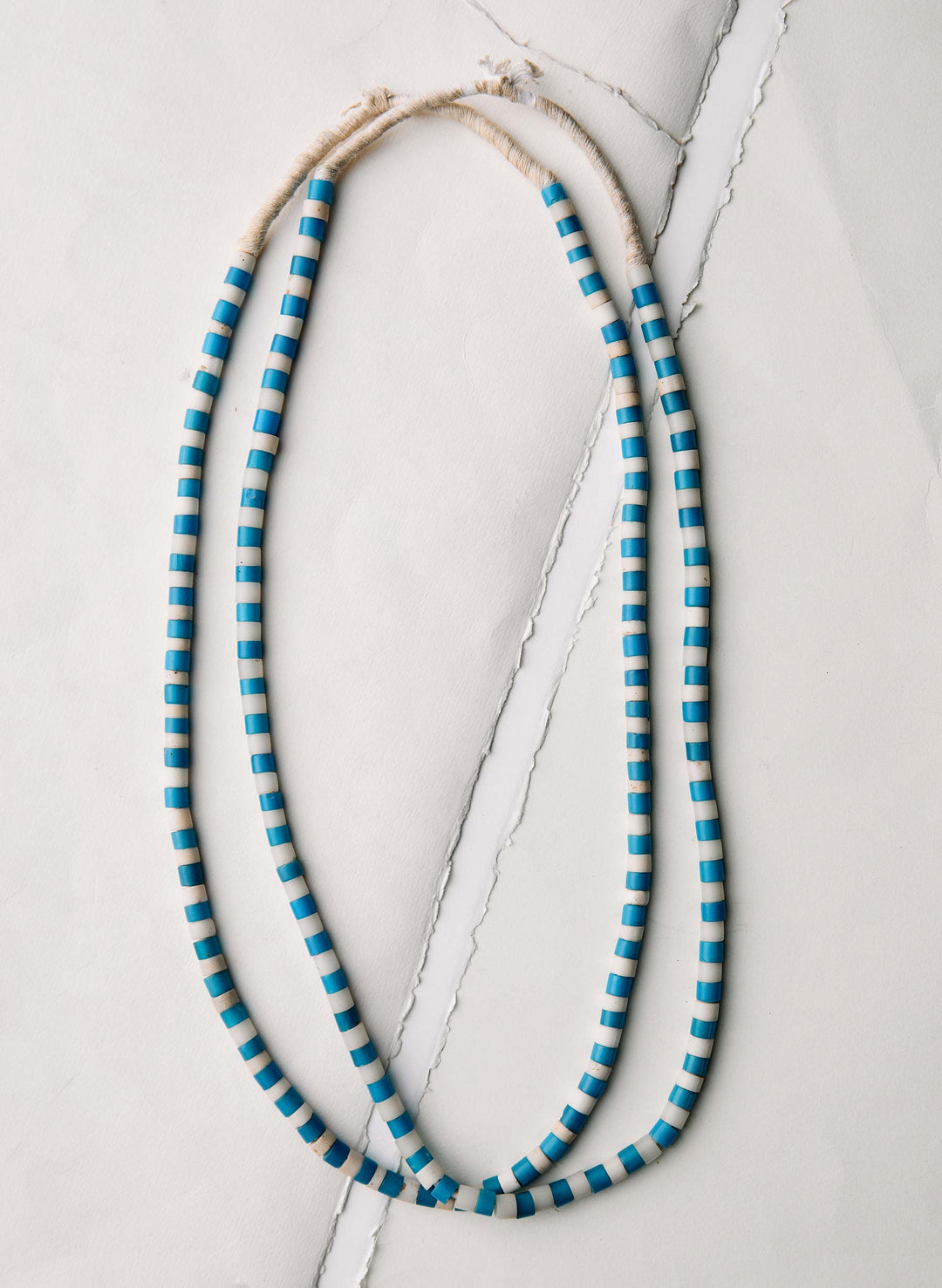 a blue and white striped necklace