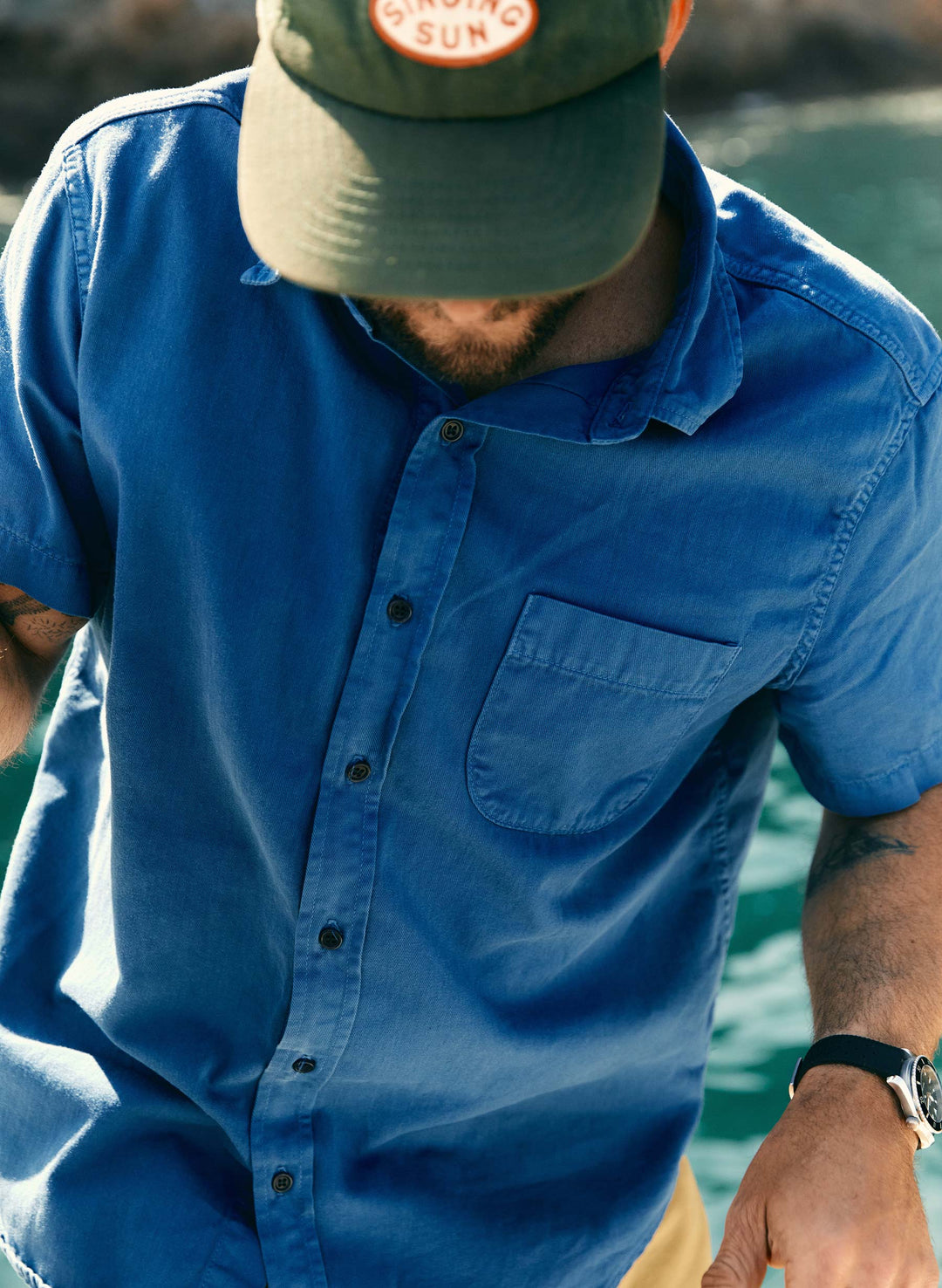 a man wearing a hat and blue shirt