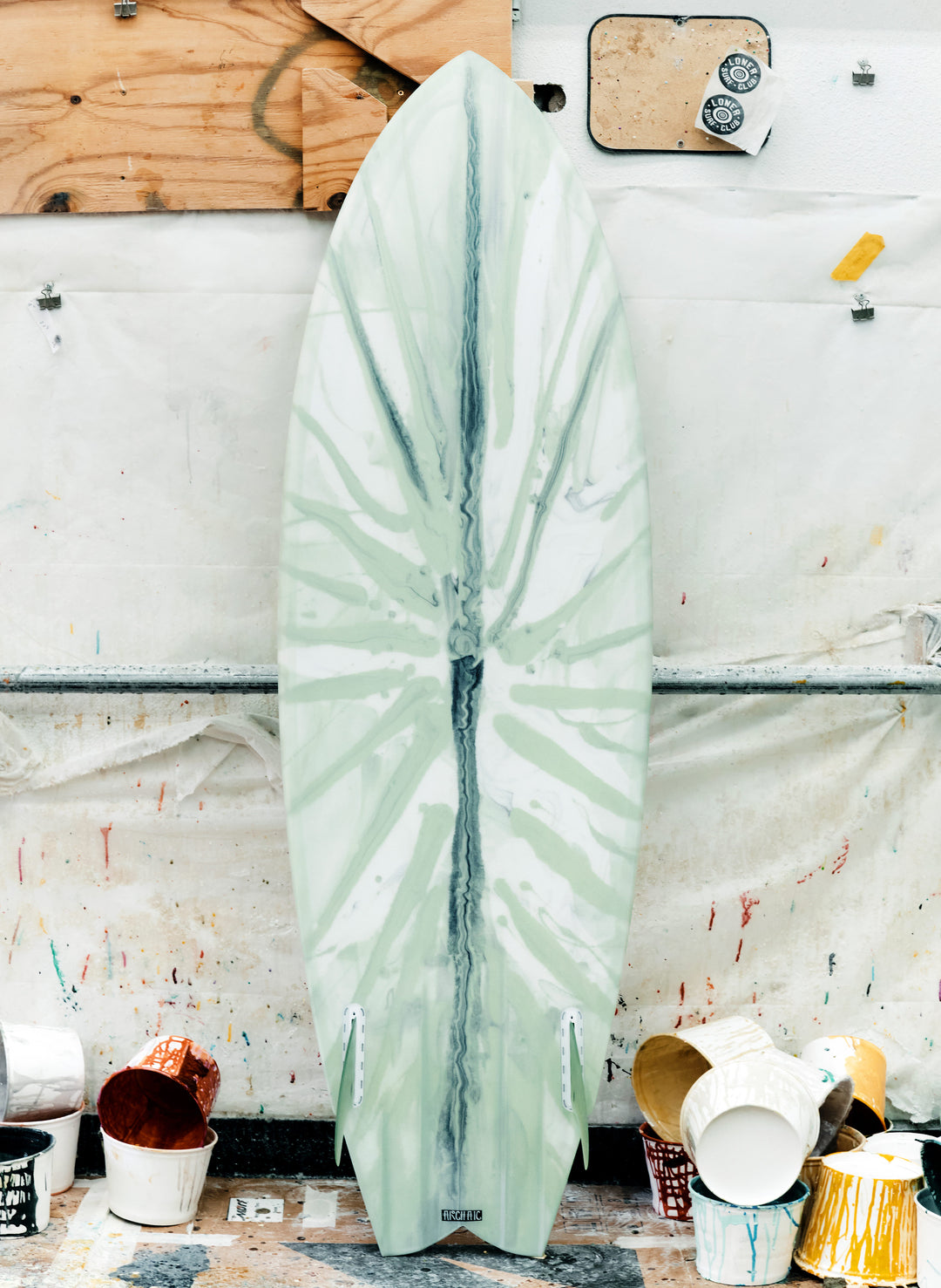 a surfboard leaning against a wall