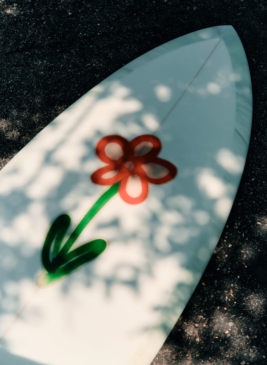 a surfboard with a flower on it