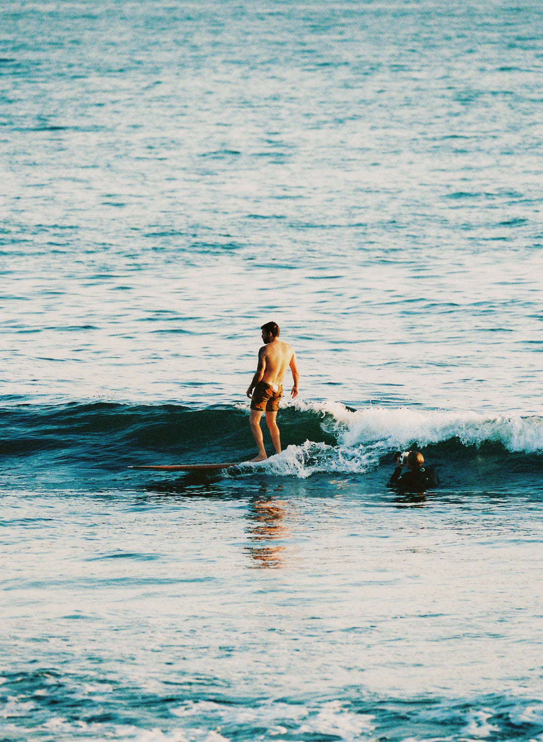 a man on a surfboard in the ocean