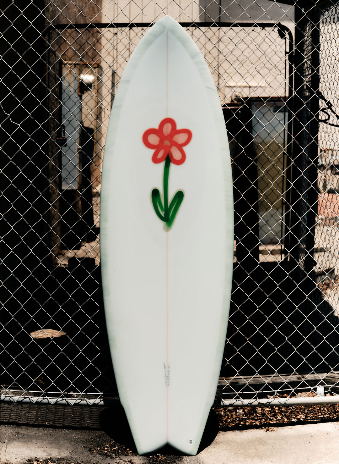 a surfboard with a flower painted on it