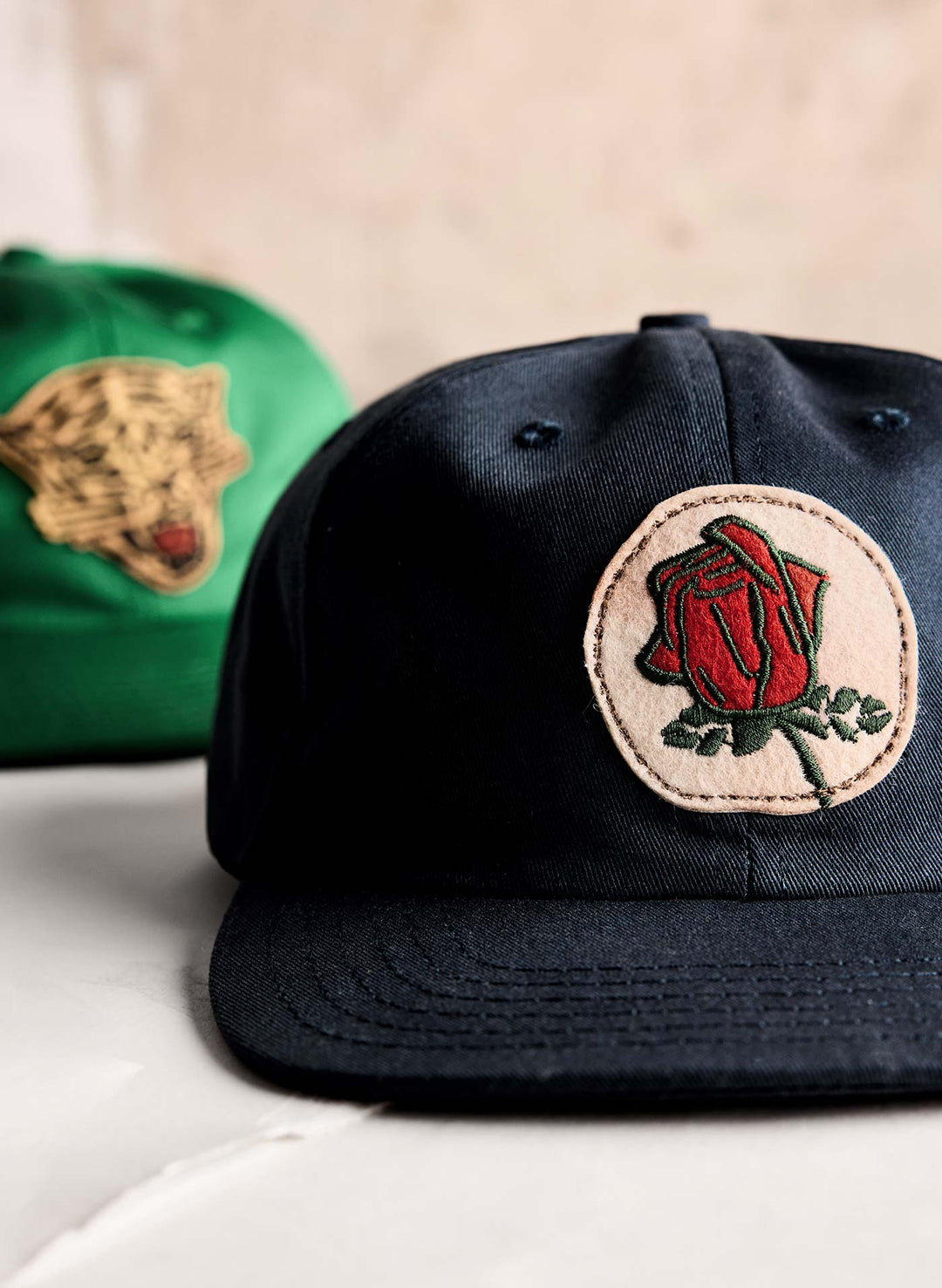 a pair of hats with a rose on it