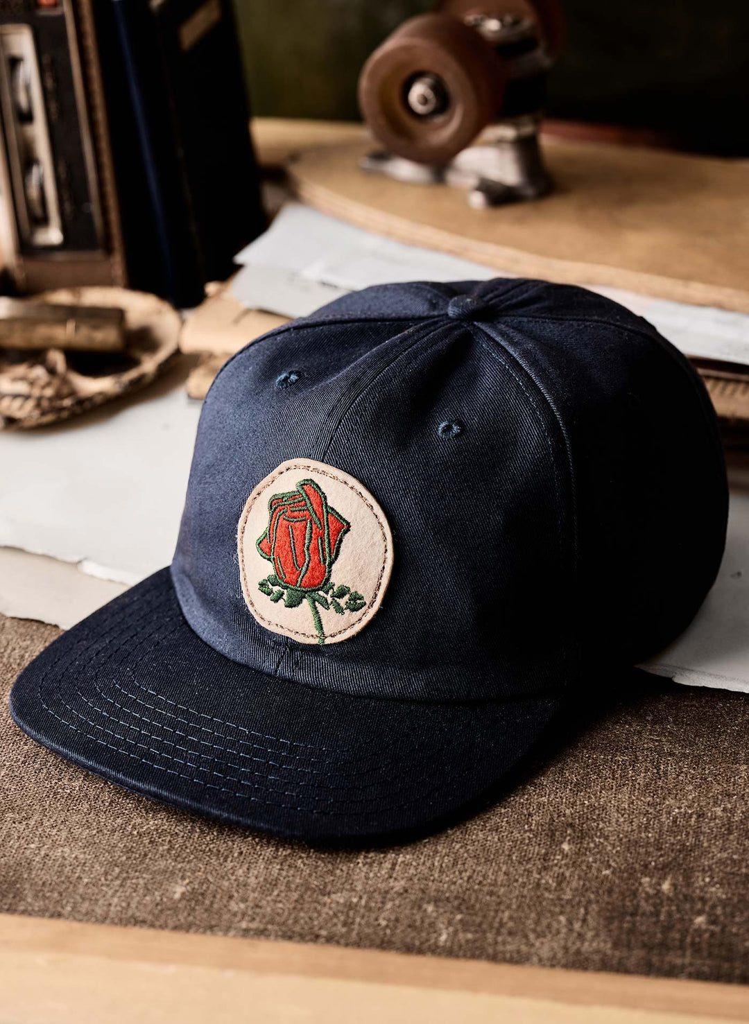 a black hat with a rose on it