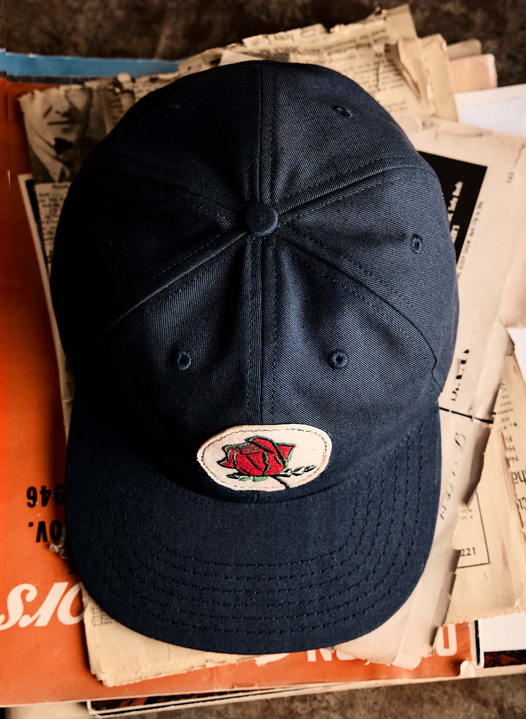 a black hat with a rose on it