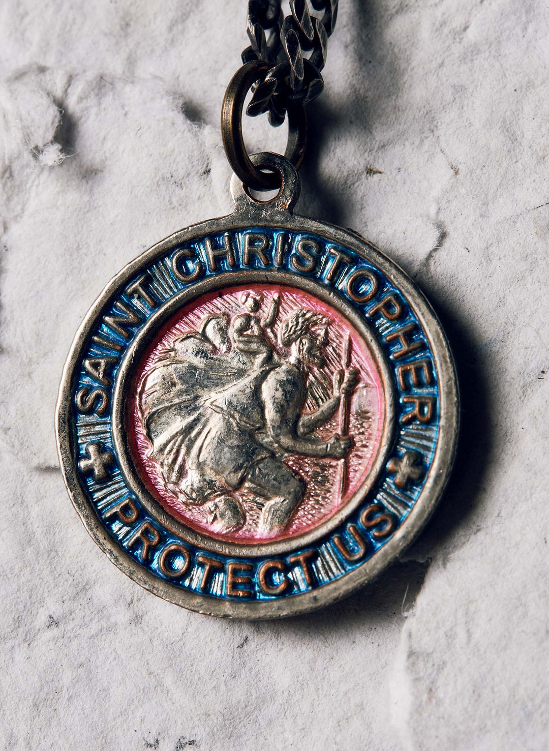 a medallion with a person holding a staff