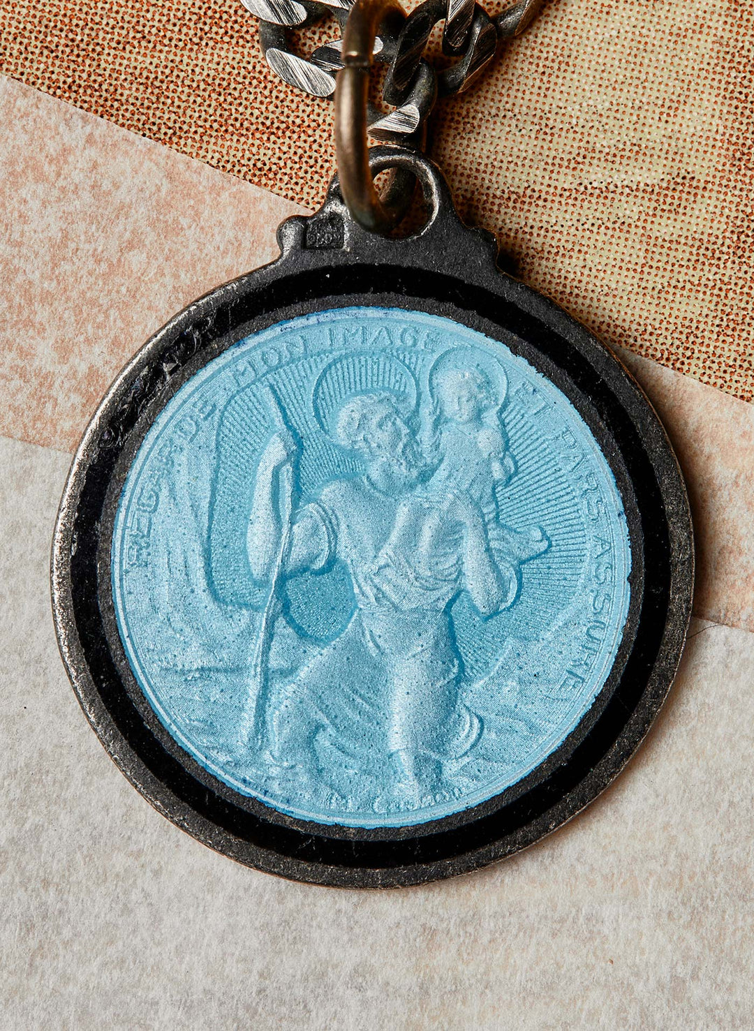 a blue medallion with a picture of a man and a child