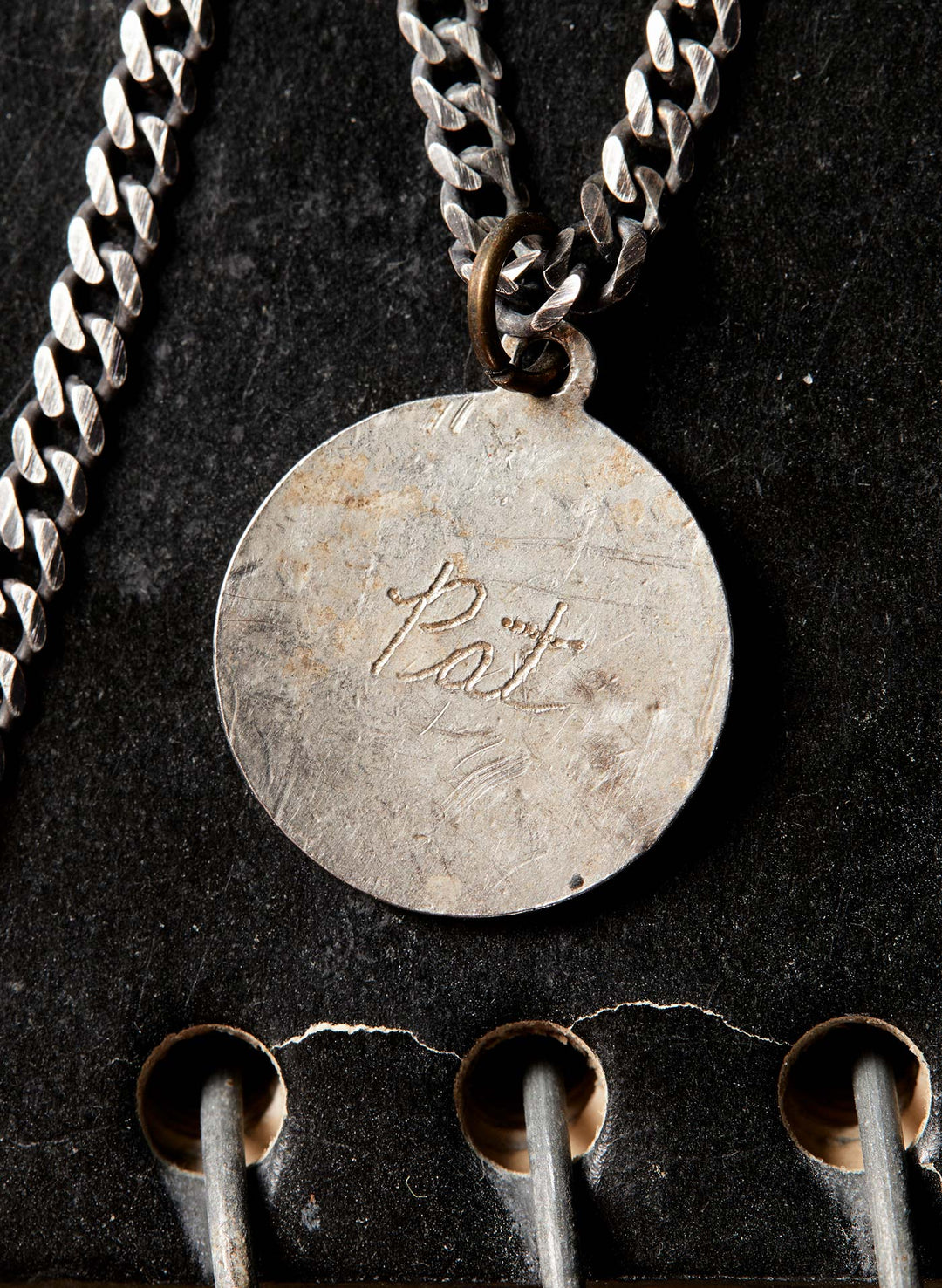 a silver coin with a chain