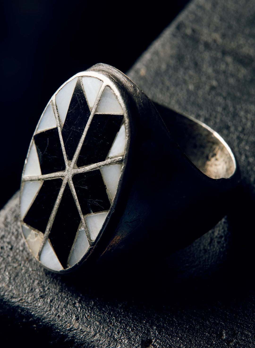 a ring with a black and white diamond design