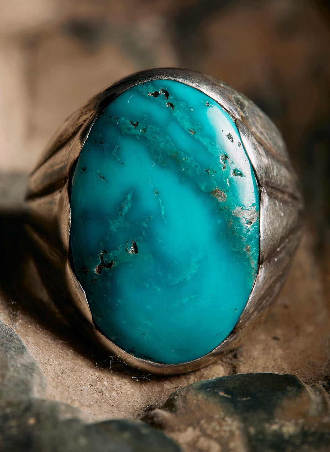 a blue stone ring on a rock