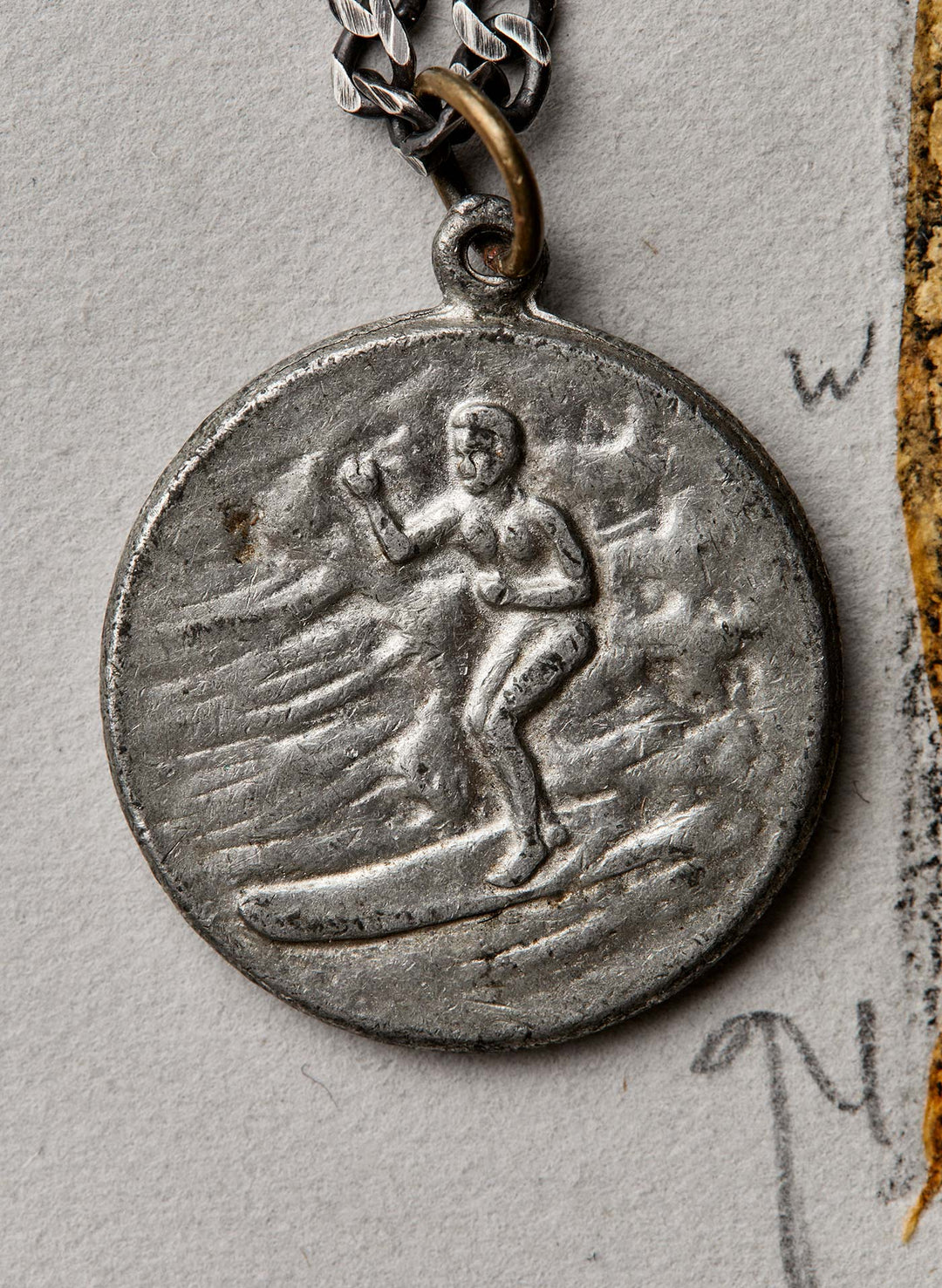 a silver medallion with a person on it