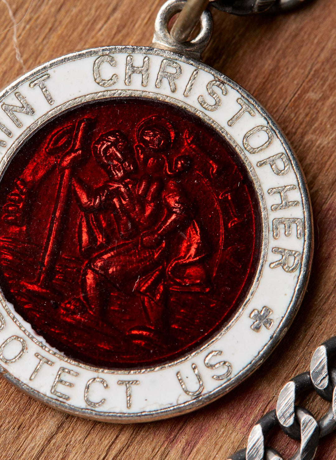 a red and white coin with a religious image on it